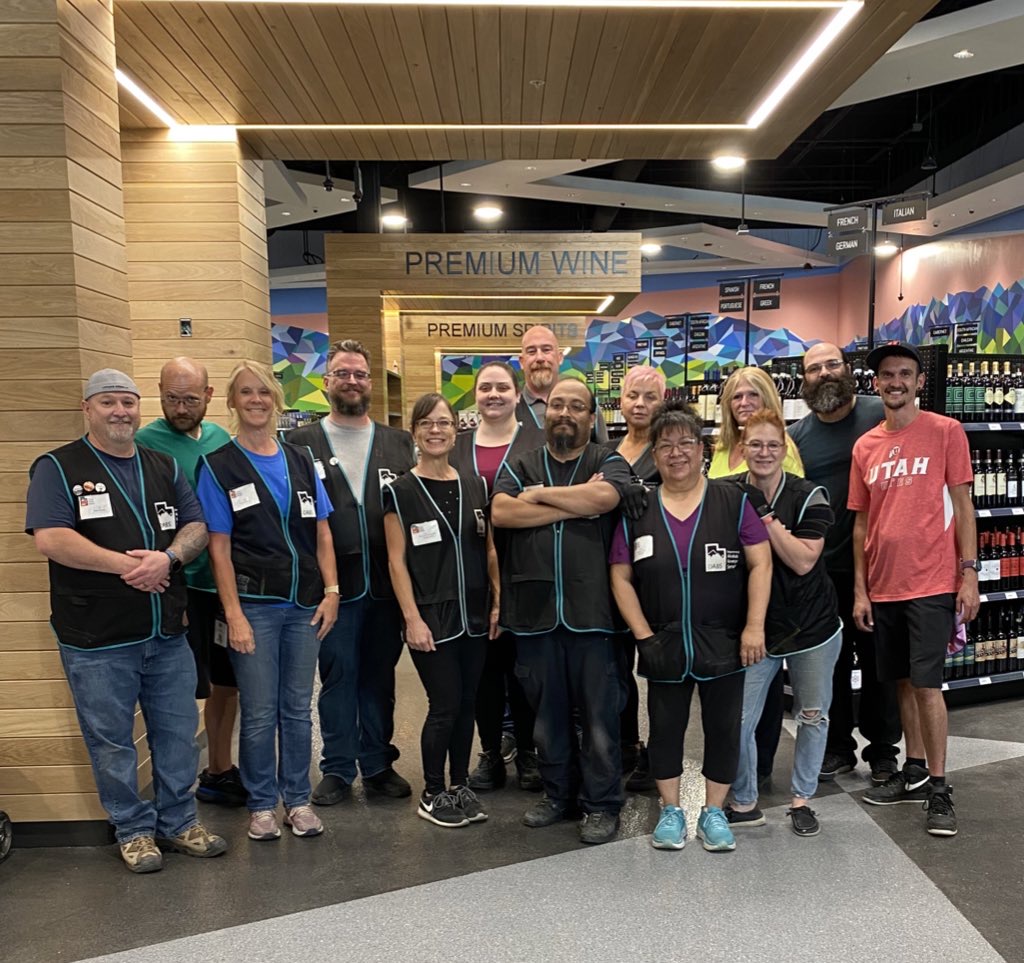 a group of DABS employees smile inside store 52 in East Sandy