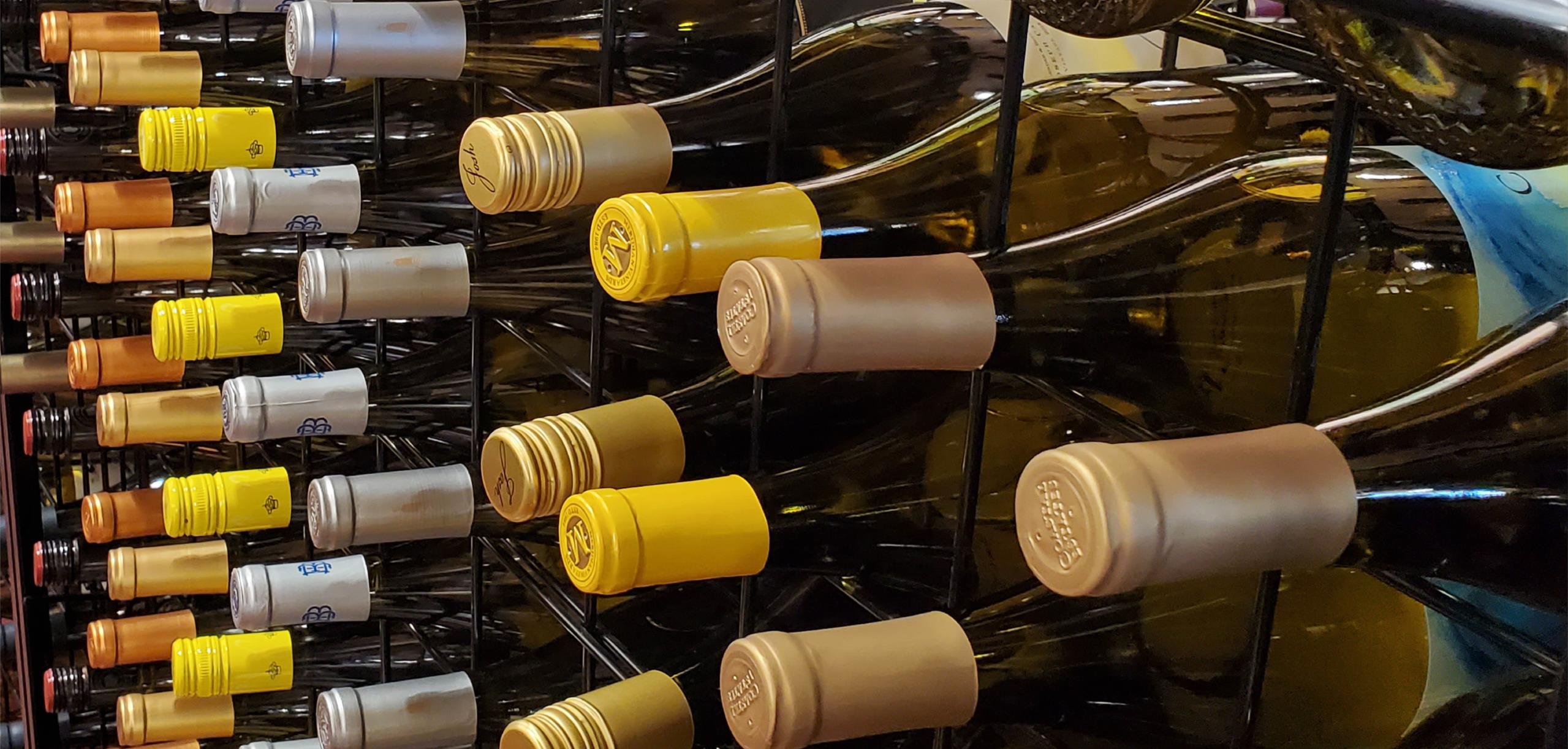 image showing wine bottles stacked in a rack at a state liquor store